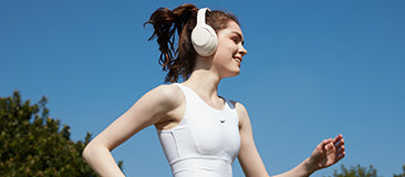 A girl in motion wearing QCY H3